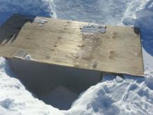 Snow pit with plywood cover
