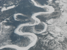 Frozen river meanders and creates oxbow lakes