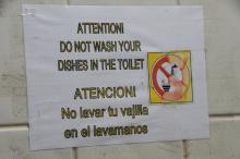 Sign for not cleaning dishes in the toilet