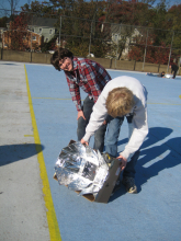 Sean and Conor aim their winning solar oven at the sun.  