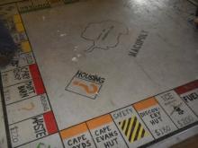 Macopoly board painted on the floor of the Berg Field Center.