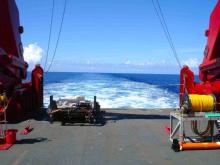 Back Deck:  The back deck of Sikuliaq, looking out between the A-frame.   The MOCNESS plankton net system is on the left.