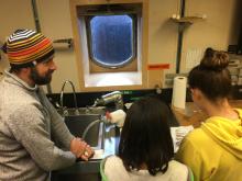 Anvil City Science Academy middle school students learn about arctic cod with Dr. Llopiz onboard the R/V Sikuliaq. Photo by Lisa Seff.  September 18, 2017.