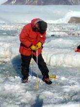 Sasha measuring ice thickness
