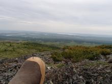 My left boot in front of the view down to the Kolyma River from near the summit 