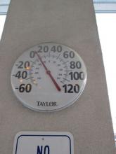 Thermometer in parking lot showing outside temperature