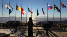 The flags of the original twelve signatory nations of the Antarctic Treaty fly at McMurdo Station's administrative building. McMurdo Station, Antarctica. Photo by Timothy R. Dwyer (PolarTREC 2016), Courtesy of ARCUS