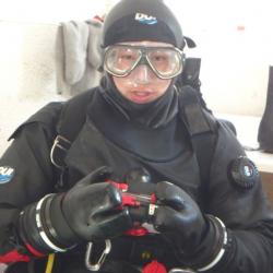 A diver in a mask and dry suit