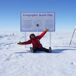 Elaine sits with her arms open at the South Pole! 