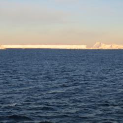 2 icebergs next to each other. Can you see the difference in their shapes?