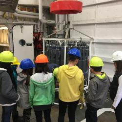 Anvil City Science Academy middle school students learn about the CTD with Dr. Okkonen and Dr. Stafford onboard the R/V Sikuliaq. Photo by Lisa Seff.  September 18, 2017.